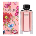 Gucci Flora perfume bottle and packaging with floral design on a pink background